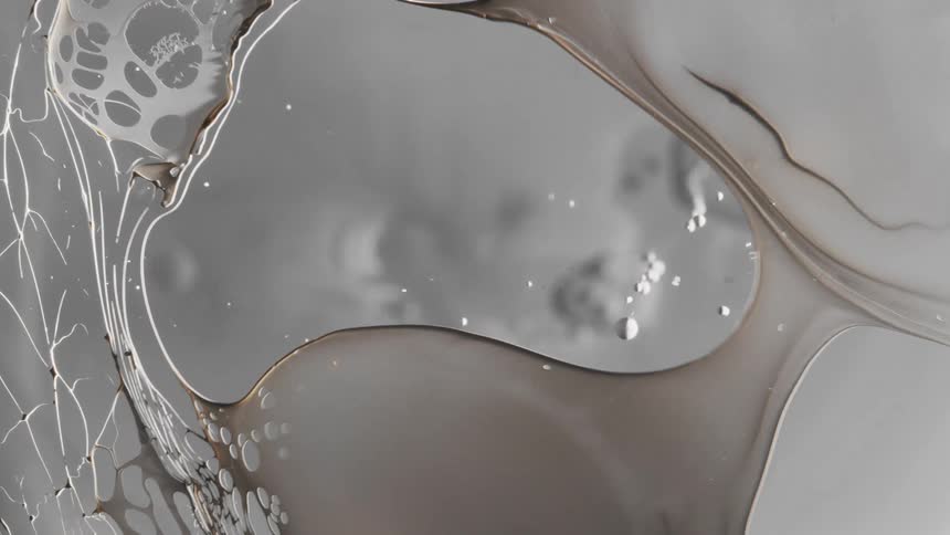 Dark liquid ink forming a film over a translucent surface and breaking