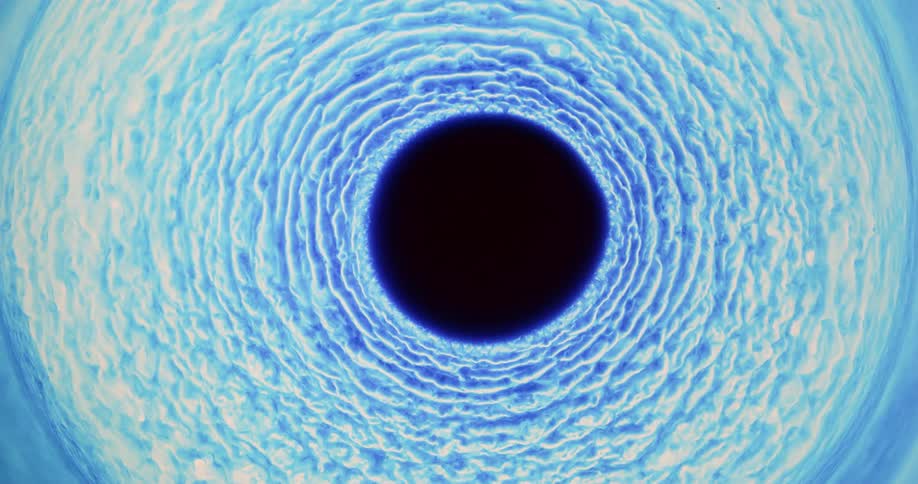 Blue swirls move around the black hole