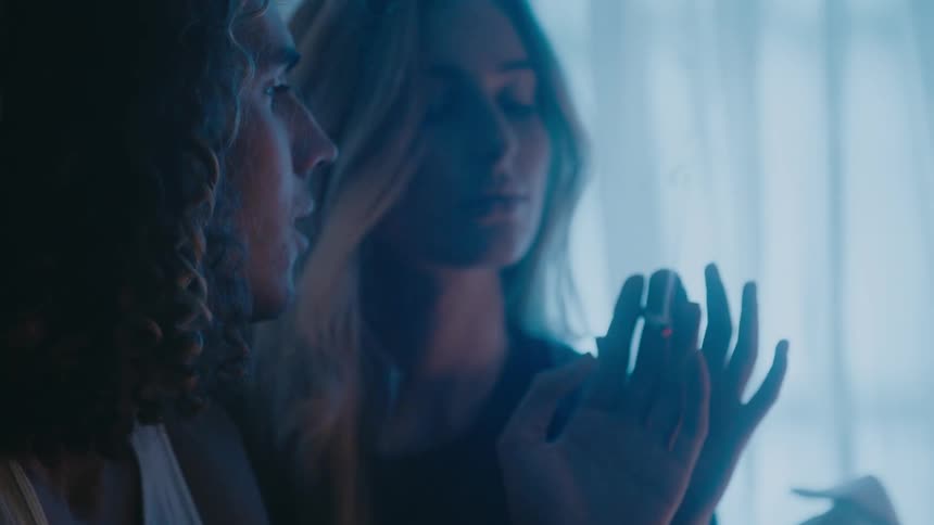 A man and woman are smoking drugs after the man lights up a joint