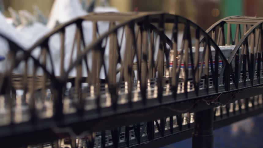 A model train passes through a bridge