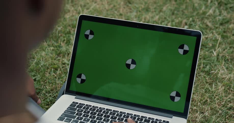 A man using a laptop outdoors