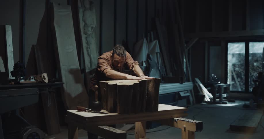 A man is rubbing the logs on the table