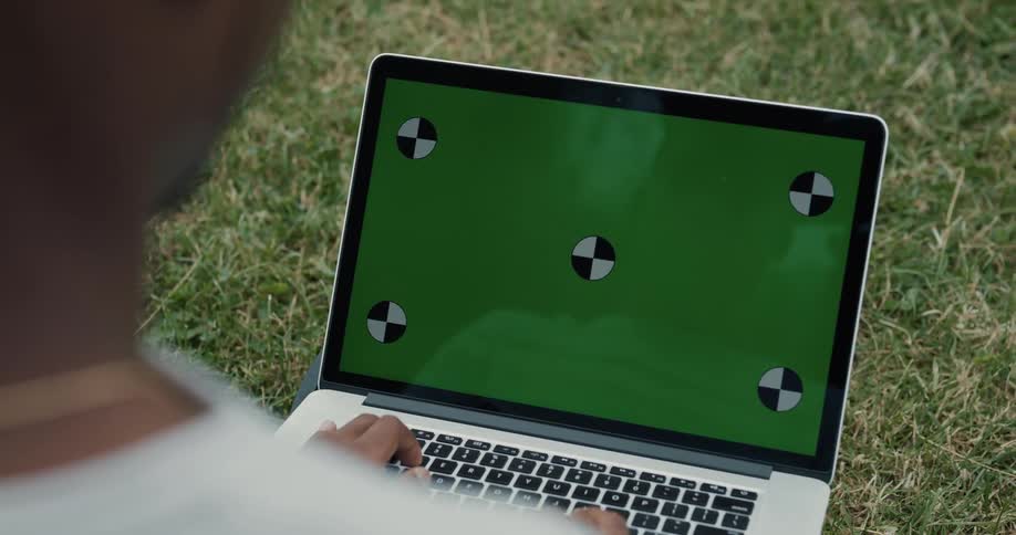 A man is typing on his laptop