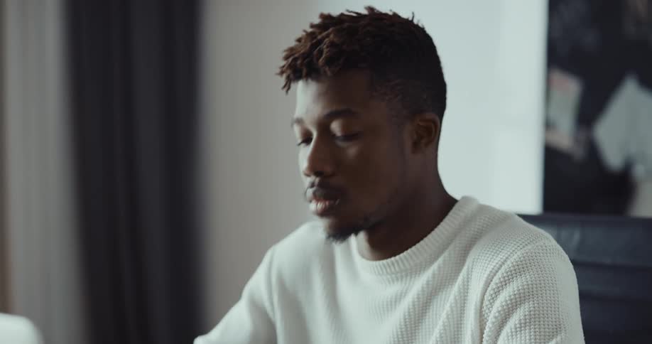 A man is sitting in his house and looks stressed