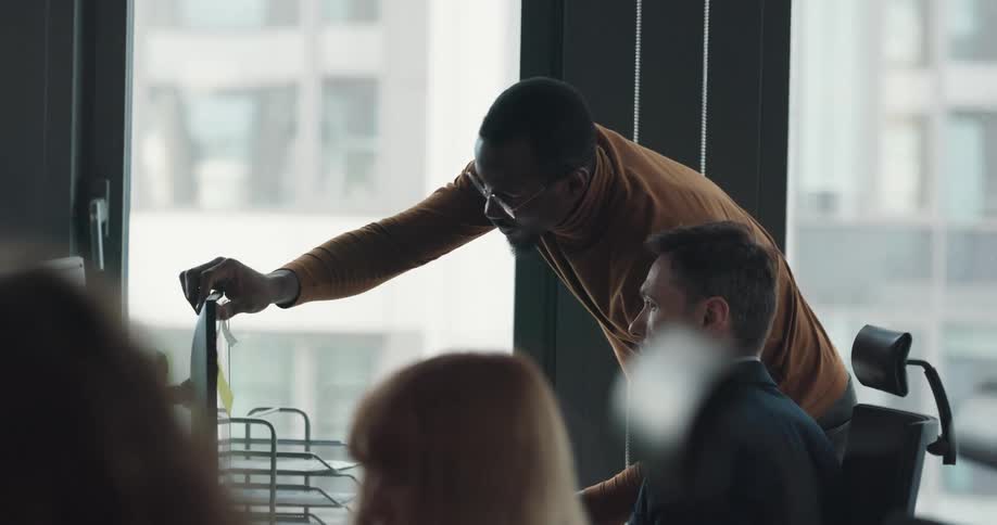 One coworker visit another and talks to him before leaving