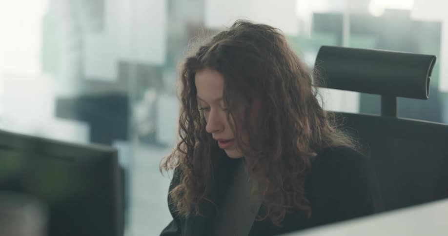 Woman is sitting in her office and by her computer