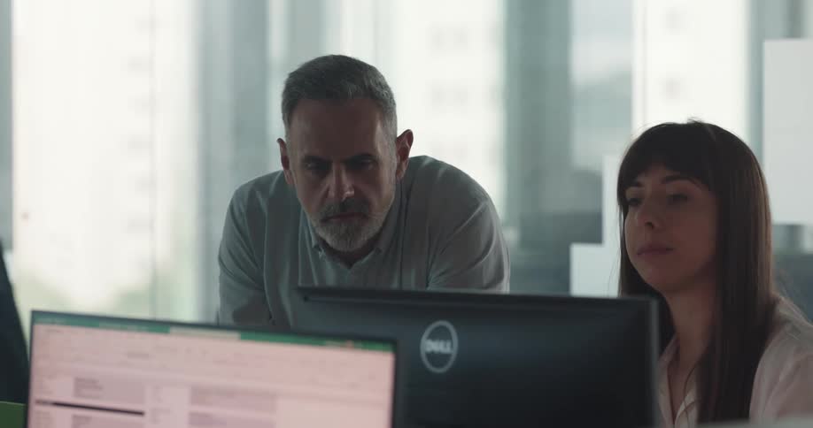 A man and woman talk in the office