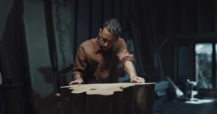 A man is feeling a large tree stump