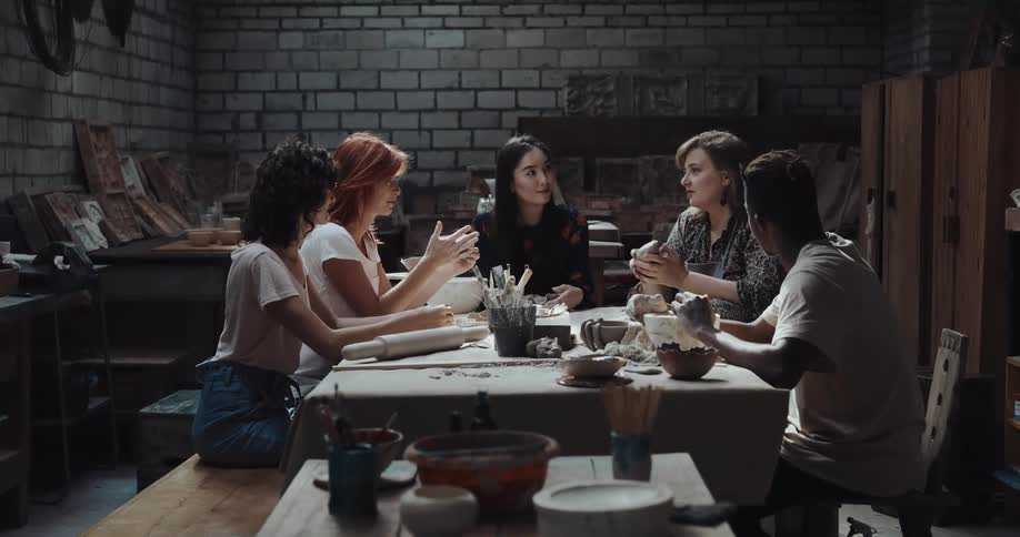 A group of friends are making pottery together