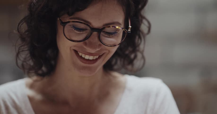 A woman is smiling and working on a hobby