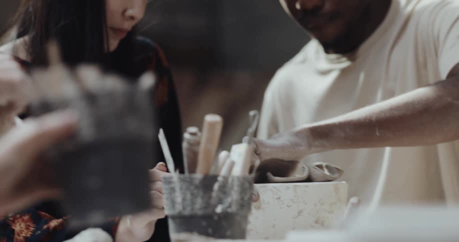 Two people work on sculpting together