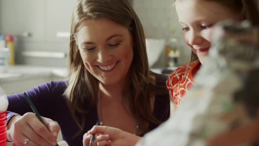 A woman and child paint together