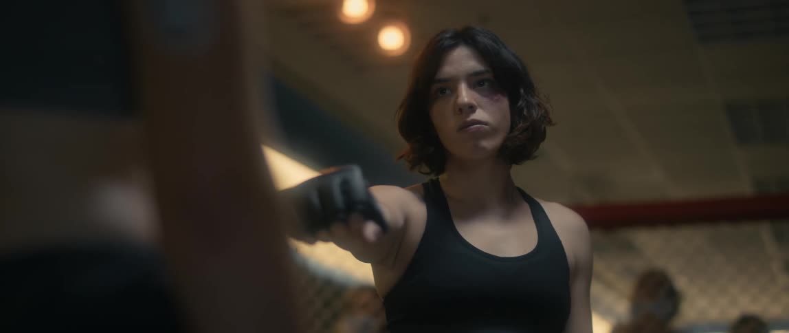 Women prepare to fight in ring as people watch