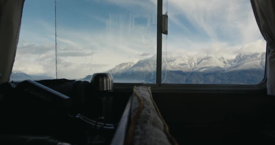 Snow capped mountains seen outside a boat window