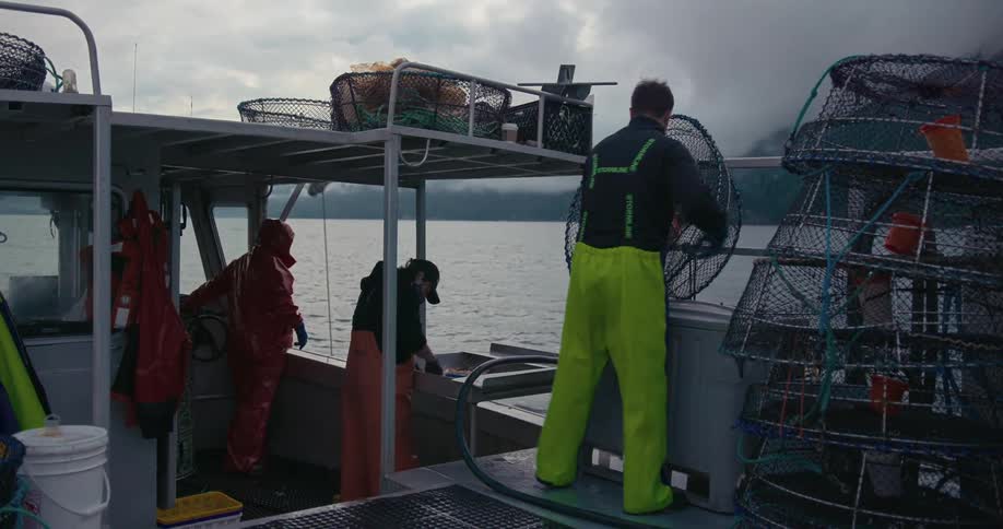 Crew on commercial fishing boat clean and reset prawn traps