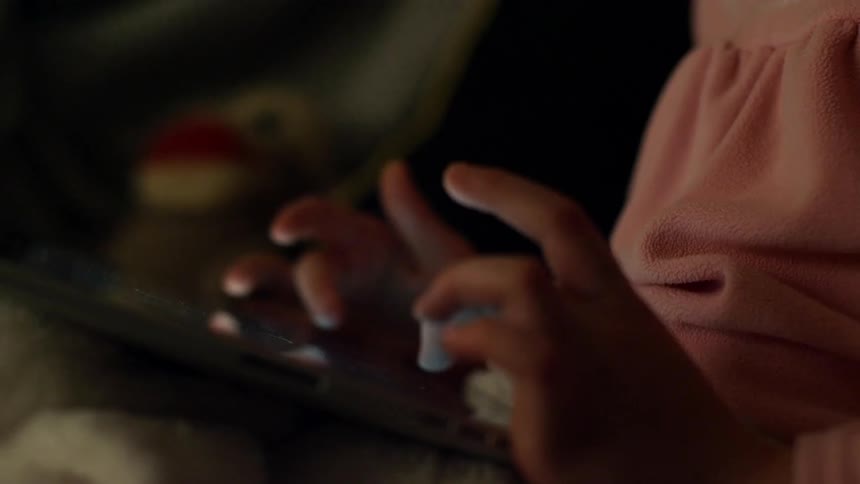 A child scrolls on a tablet