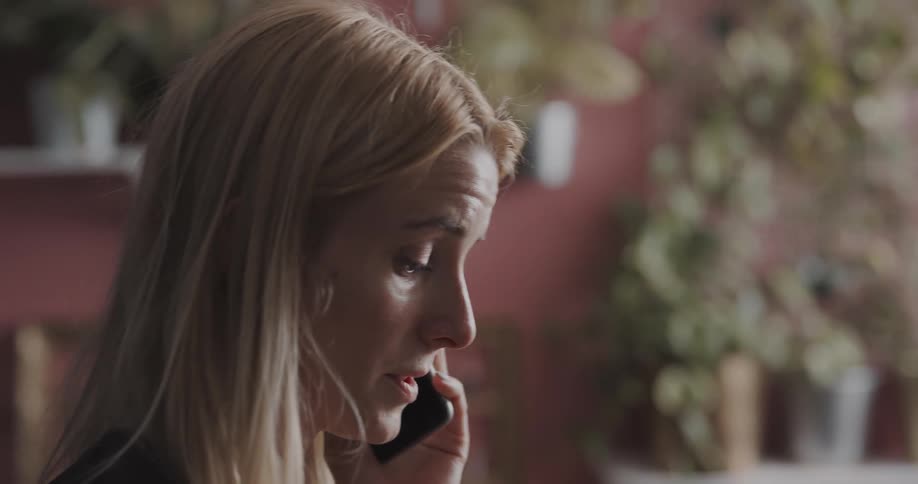 A woman is talking on a cell phone during the daytime