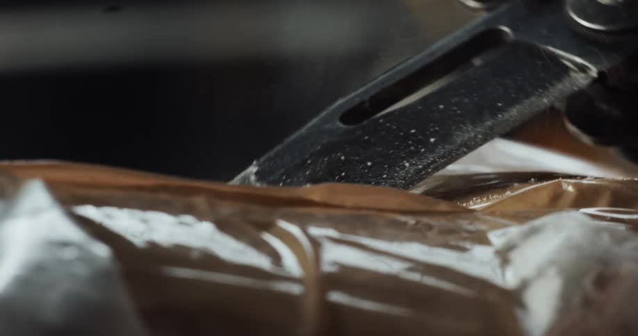 Blade is used to cut into an remove part of powder substance
