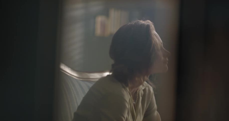A woman is sitting on a couch in a room