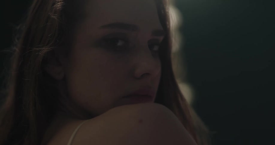 Close up of the face of a woman that turns to look at the camera