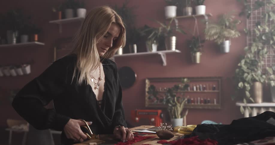 A tailor is cutting fabric