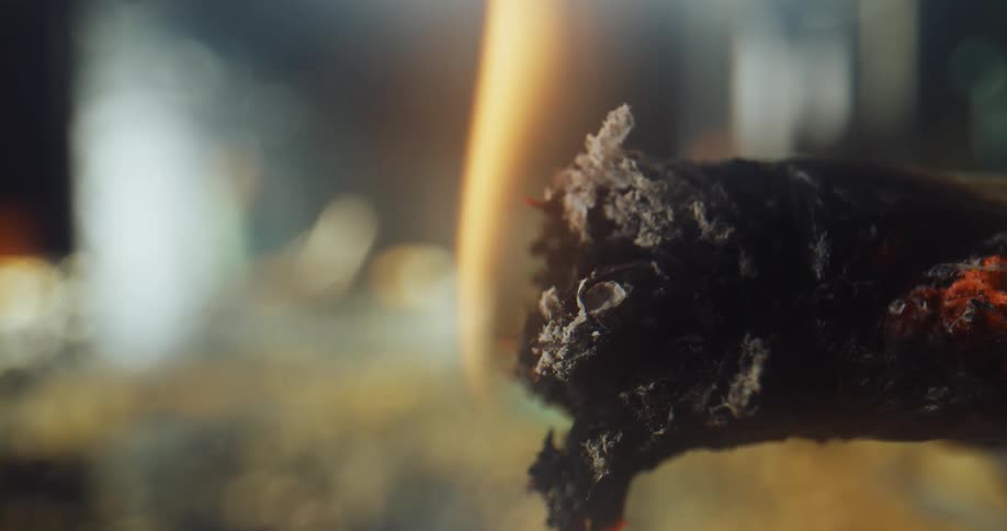 Fire burning the tip of a lit cigarette