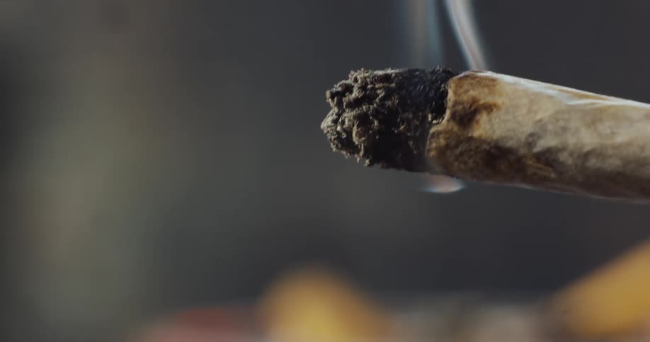 A cigarette is giving off smoke