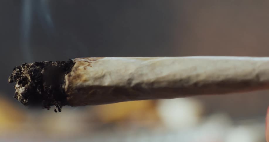 Extreme close up taking a hit off a joint