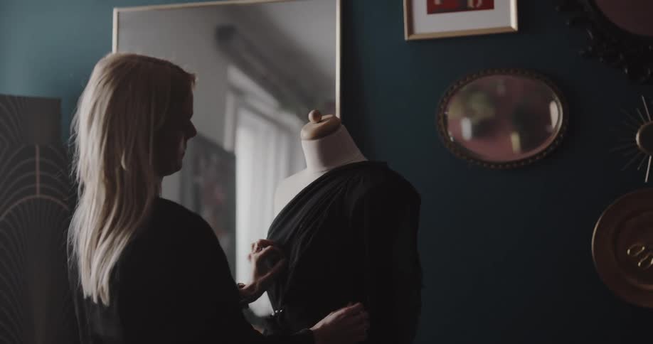A tailor is working by the window