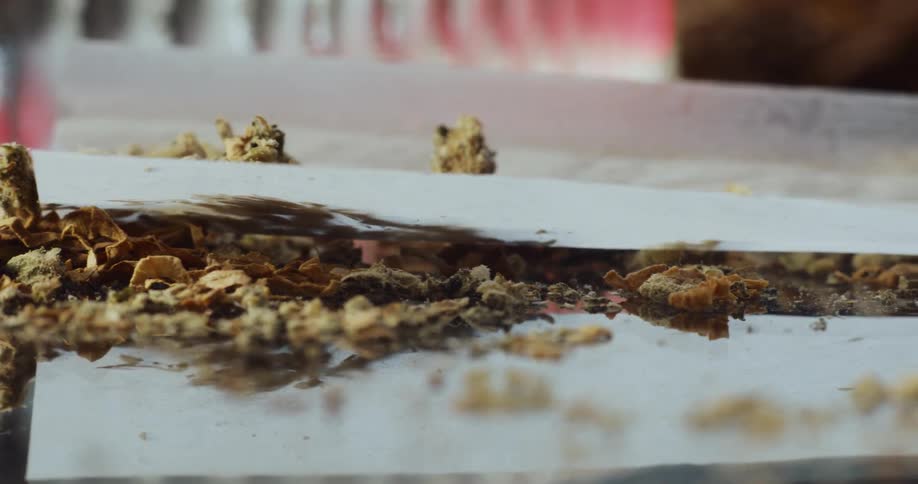 Crumbled pieces of food falling on waxed paper