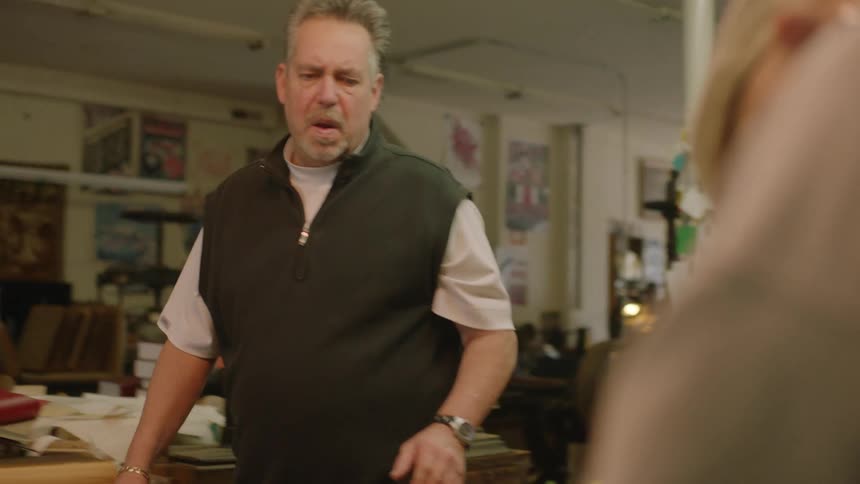 A man approaches the counter in a workshop