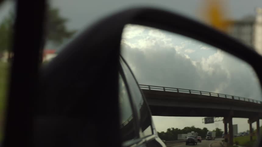 Bridge reflecting on the side mirror of a moving vehicle