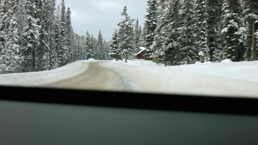 A car is driving through the snow