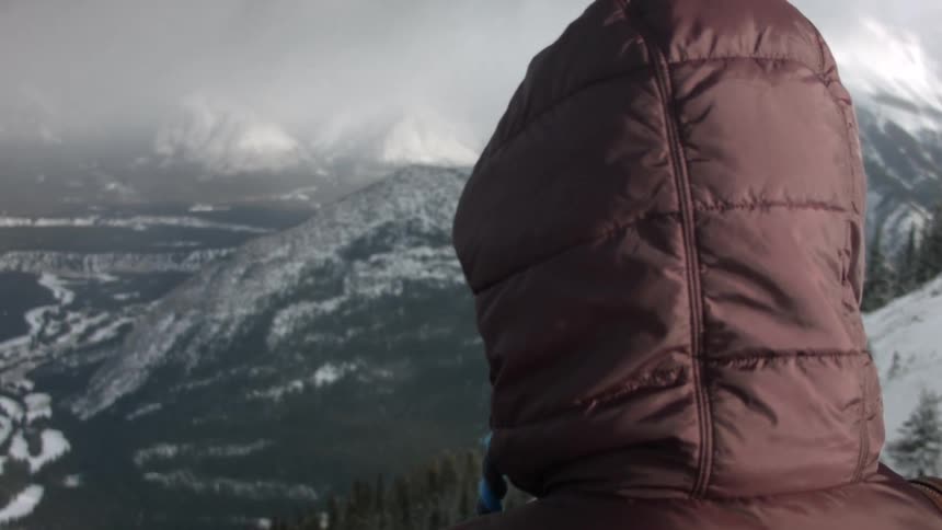 A person looking down at a valley