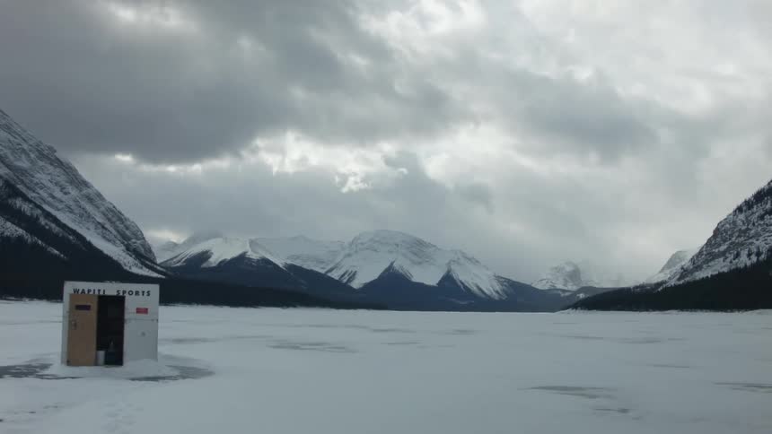 Snow capped mountains against a cloudy sky