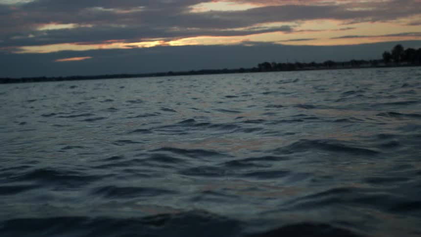 The water is rough at sunset