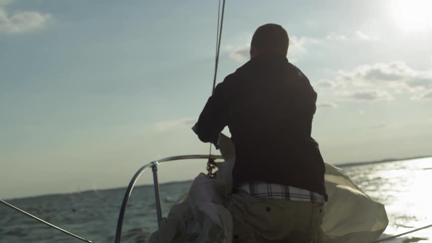A man pulls down his sail