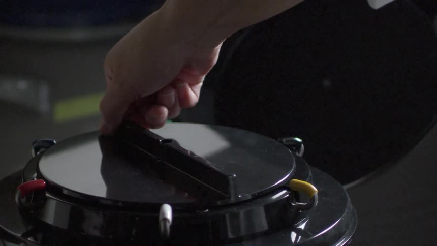 A container lid is opened, then a lid is lifted up with steam coming off it