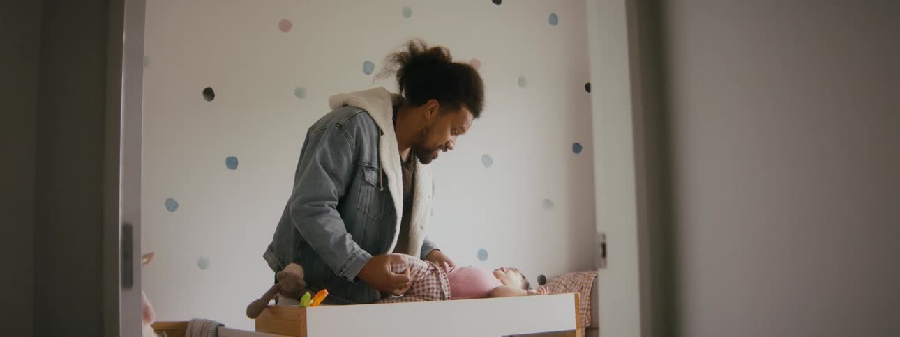 Father places daughter on changing table