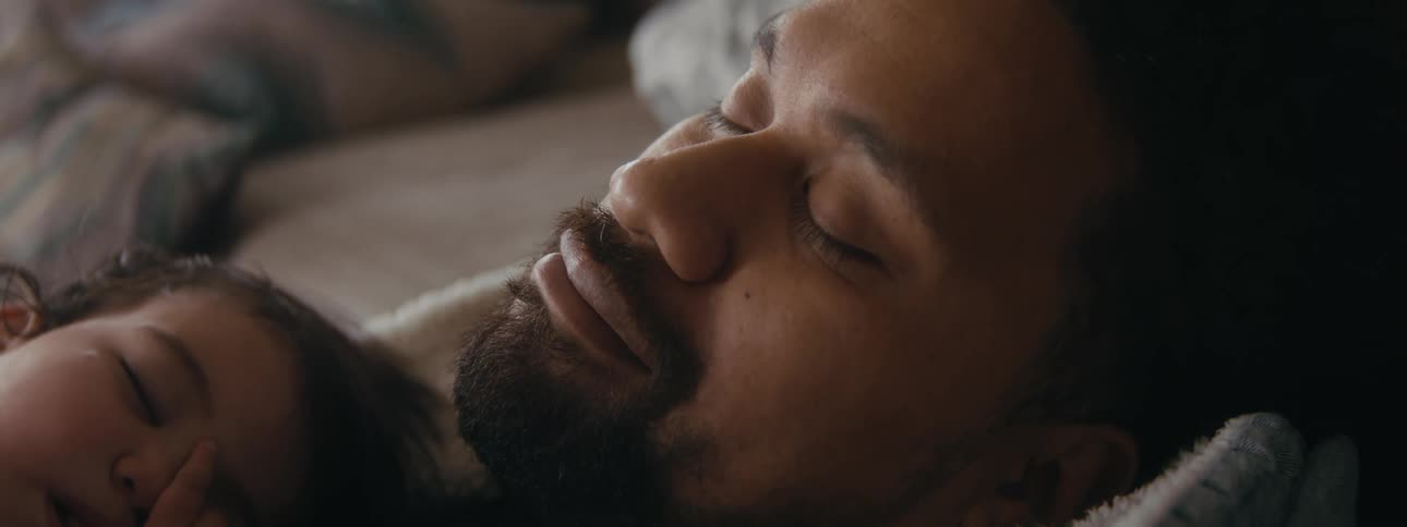 A man sleeping in bed at home