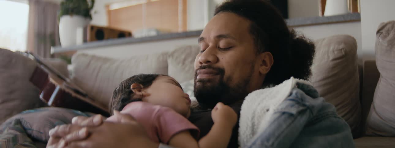 A father and son napping in a room