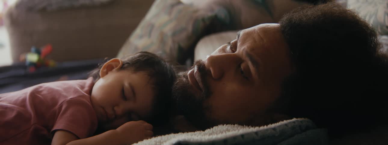 A man is resting with his child