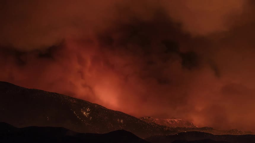 Clouds forming in a dark orange sky at night