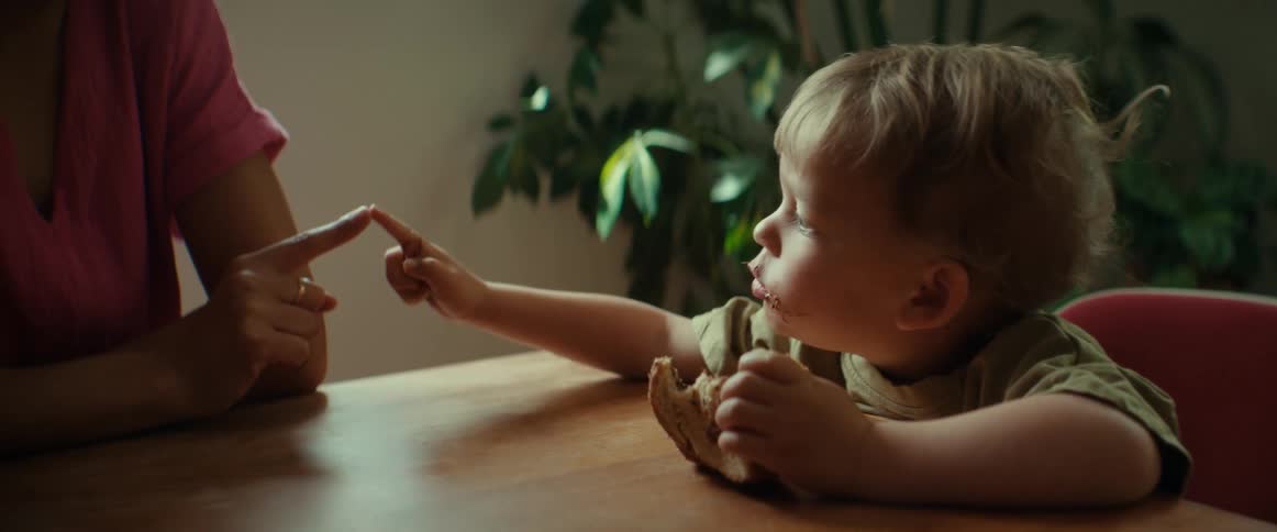 A child is sitting at a table and eating food