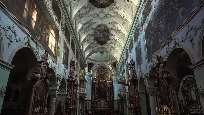 Sunlight glows and shimmers on the paintings and sculptures of st peters abbey in salzburg