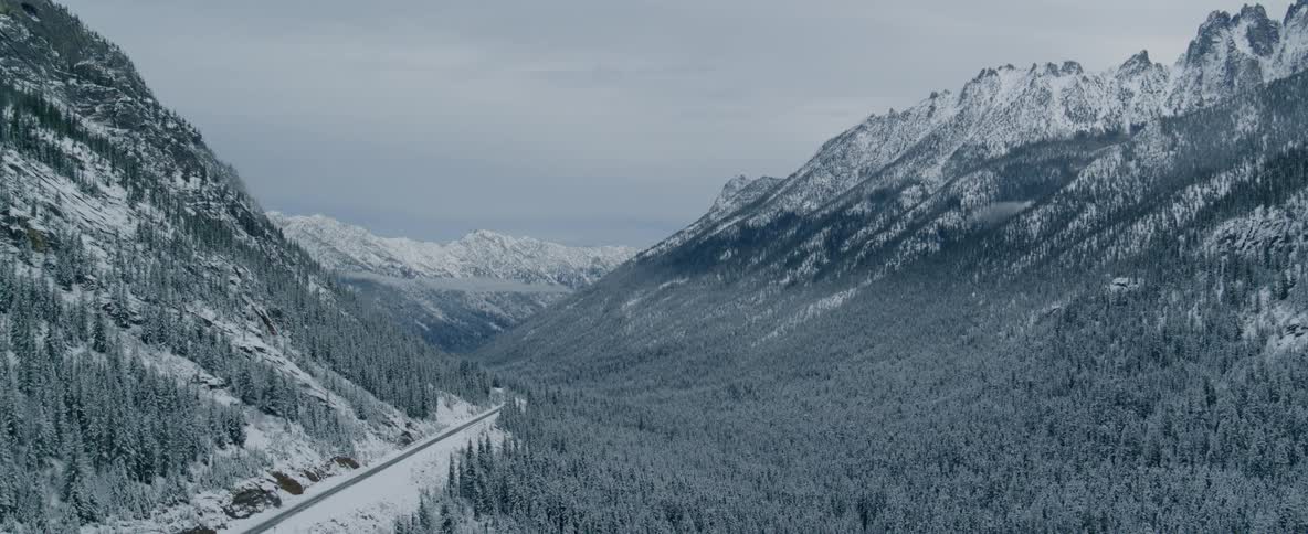 A road along a snowy mountain scape