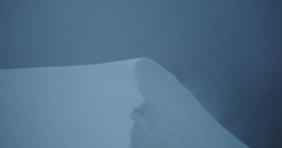 Snow blowing on a hill during a snowstorm