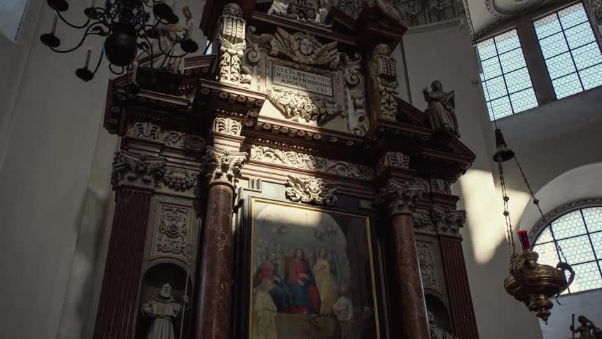 Sun and shadow flow across ornate religious art at the alter of cathedral