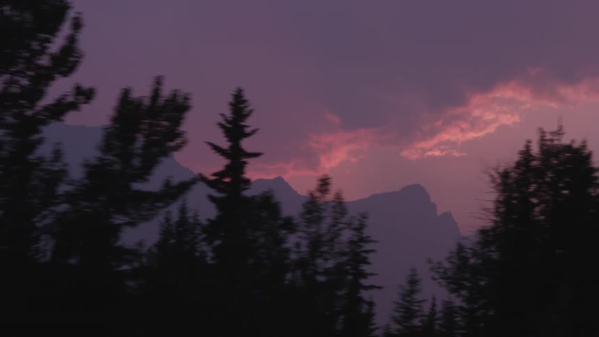 A mountain at sunset on a cloudy day