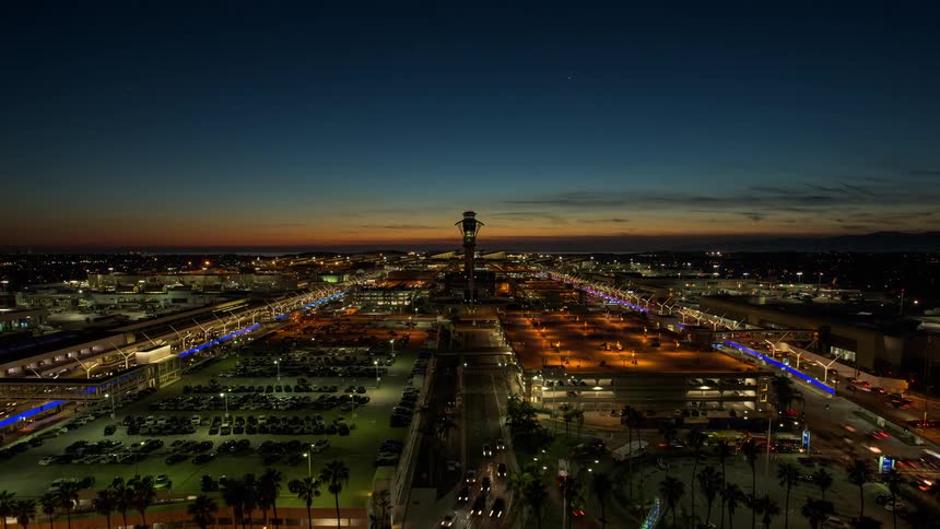 Time lapse of vehicles driving from up high at LAX airport camera pans up